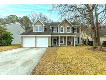 Charming two-story home featuring a two-car garage, well-kept lawn, and traditional architectural details at 129 Isherwood Dr, Goose Creek, SC 29445