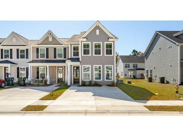 Charming two-story townhome with a modern gray exterior and well-manicured landscaping at 213 Abercom Place Dr, Moncks Corner, SC 29461