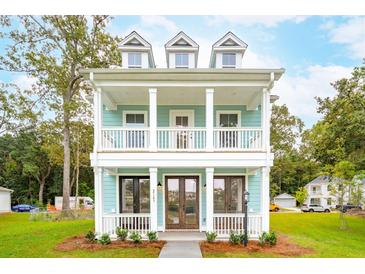 Charming two-story home with a covered porch and balcony, featuring a light blue exterior and white trim at 2181 Blue Bayou Blvd, Johns Island, SC 29455
