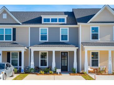 Charming townhome with a welcoming front porch and neat landscaping at 221 Abercom Place Dr, Moncks Corner, SC 29461