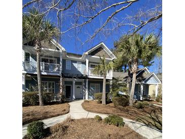 Inviting two-story blue townhome with a charming walkway, white trim, and well-maintained landscaping at 2905 Sweetleaf Ln, Johns Island, SC 29455