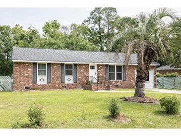 Charming brick home featuring a well-manicured lawn and mature trees at 2916 Marginal Rd, Charleston, SC 29414