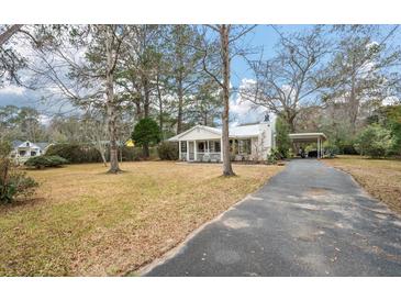 Charming single-story home features a manicured lawn and a convenient carport, blending comfort and practicality at 3589 Walter Dr, Johns Island, SC 29455