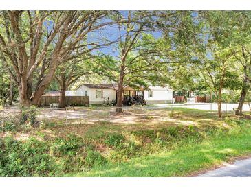 Charming single-story home featuring an ample front yard and mature trees at 317 Lankford St, Moncks Corner, SC 29461