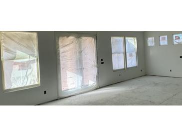 Bright living room featuring multiple windows and a sliding glass door at 324 Abercom Place Dr, Moncks Corner, SC 29461