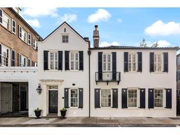 Charming home featuring classic architectural details and symmetrical design with black shutters at 35 Tradd St, Charleston, SC 29401