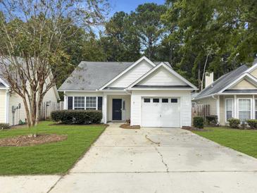 Charming home with attached garage, neat landscaping and driveway at 4875 Carnoustie Ct, Summerville, SC 29485