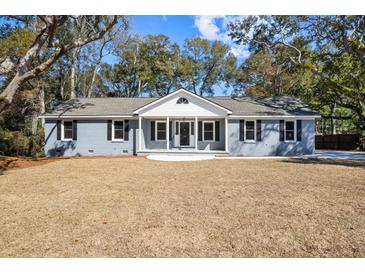 Charming blue brick home with a well-manicured lawn, inviting curb appeal and a quaint covered entrance at 782 Bonham Dr, Charleston, SC 29412