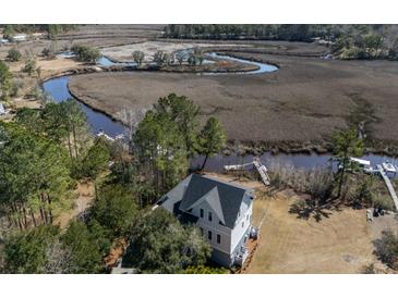 Stunning aerial view of home with marsh views, deep-water access, and private dock at 7527 Ladys Secret Ln, Awendaw, SC 29429