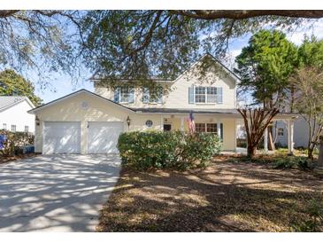 Charming two-story home features a spacious two-car garage and inviting front porch at 1051 Wayfarer Ln, Charleston, SC 29412