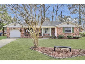 Charming single story brick home with a manicured lawn and attached garage at 108 Gambels Ln, Summerville, SC 29485