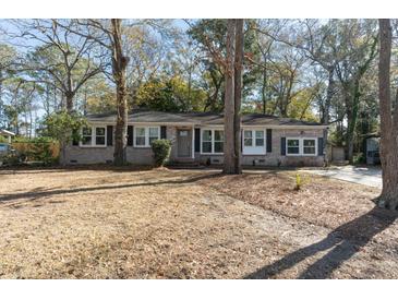 Charming brick home with well-maintained landscaping and mature trees at 1239 Wappetaw Pl, Mount Pleasant, SC 29464