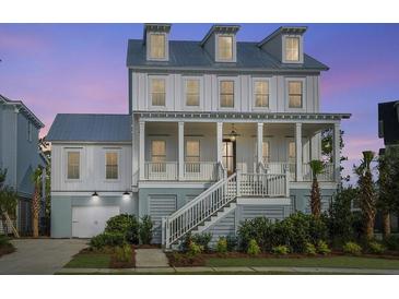 Beautiful two-story home featuring a welcoming front porch, landscaped yard, and a charming coastal design at 1468 Alligator Creek Ct, Awendaw, SC 29429