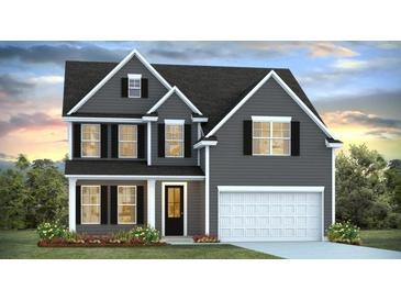 Charming two-story home with gray siding, black shutters, and a well-manicured lawn at 201 Seele St, Lincolnville, SC 29485