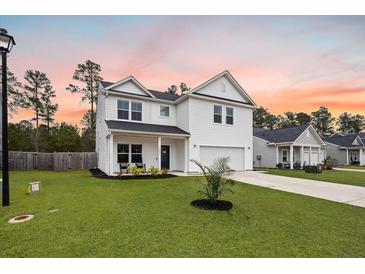 Charming two-story home featuring a landscaped front yard and inviting covered porch at 217 Lucca Dr, Summerville, SC 29486