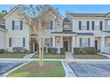 Inviting exterior view of townhomes with manicured lawns, blue shutters, and covered entryway at 249 Brookshire Rd, Goose Creek, SC 29445