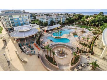 Expansive resort pool area with multiple pools, fire pit, and ocean views at 5800 Palmetto Dr # Vg-105, Isle of Palms, SC 29451