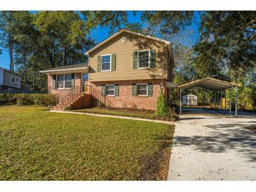 Charming two-story home with a brick facade, manicured lawn, and covered parking at 7639 Northhaven Dr, North Charleston, SC 29420