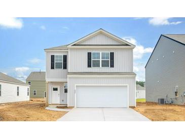 Charming two-story home with a light gray exterior, black shutters, a large garage and a concrete driveway at 838 Lilyford Ln, Summerville, SC 29486