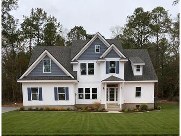 Charming two-story home boasts a well-manicured lawn, white siding, blue accents, and inviting front porch at Ln, Walterboro, SC 29488