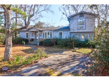 Charming two-story home features blue siding, complemented by mature trees and landscaping at 133 Stephanie Cir, Summerville, SC 29483