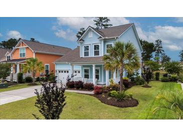 Charming two-story home features light blue siding, front porch, attached garage, and professionally landscaped front yard at 149 Calm Water Way, Summerville, SC 29486