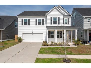 Charming two-story home features white siding, black shutters, and a welcoming front porch at 208 Evergreen Ave, Summerville, SC 29485