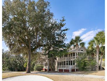 Beautiful two-story home with a large yard, mature trees, and inviting balconies at 2784 Hidden Oak Dr, Seabrook Island, SC 29455
