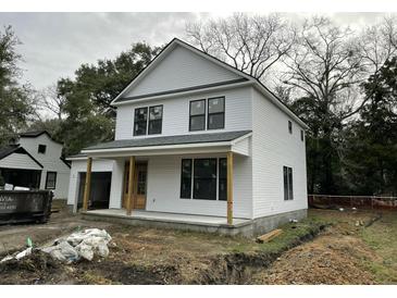 Charming two-story home featuring white siding, a welcoming front porch, and classic architectural details at 5806 Beverly Dr, Hanahan, SC 29410
