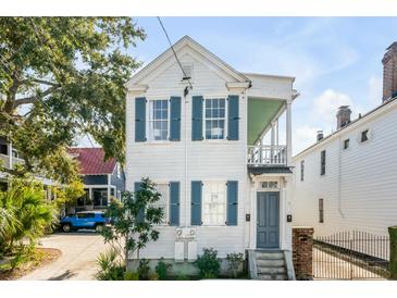 Charming two-story home with blue shutters, and a quaint second-story porch at 107 Bogard St, Charleston, SC 29403