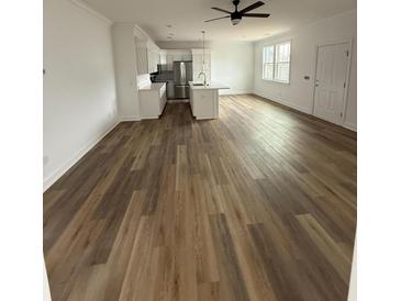 Spacious living room featuring modern lighting, wood-style flooring, and a bright, airy open floor plan at 1137 Moss Grove Dr Dr, Moncks Corner, SC 29461