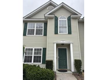 Charming front entrance featuring a dark green door with sidelights, complemented by manicured landscaping for added curb appeal at 1545 Ashley River Rd # 3K, Charleston, SC 29407