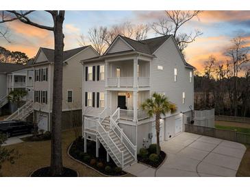 Charming two-story coastal home with double porches and manicured landscaping, great curb appeal at 1918 Essex Farms Dr, Charleston, SC 29414