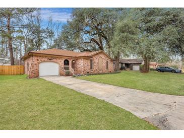 Charming brick home with a well-manicured lawn and a long driveway leading to the attached garage at 201 Maple Dr, Summerville, SC 29485