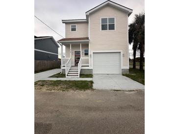 Charming two-story home with a spacious front yard and a convenient attached garage at 2100 Booker St, Charleston, SC 29405