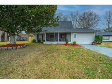 Charming single-story home with a landscaped front yard, mature tree, and a screened-in porch at 240 Horseshoe Dr, Goose Creek, SC 29445