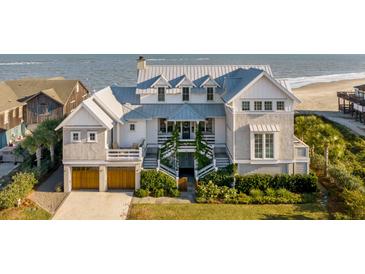 Stunning beach house featuring multi-level decks, meticulous landscaping, and direct ocean access at 3001 Marshall Blvd, Sullivans Island, SC 29482