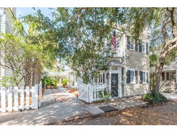 Charming home featuring a cozy front yard and white picket fence at 36 Bogard St, Charleston, SC 29403