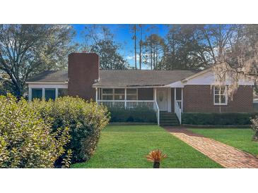 Charming single-story brick home with a well-manicured lawn and inviting front porch at 409 Dowling Ave, Walterboro, SC 29488