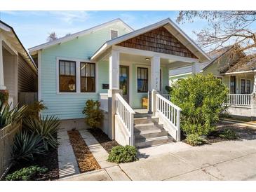 Charming home featuring a covered front porch, manicured landscaping, and stylish architectural details at 721 Meeting St, Charleston, SC 29403
