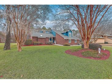 Charming two-story brick home with a well-manicured lawn and colorful landscaping at 131 Londonderry Rd, Goose Creek, SC 29445