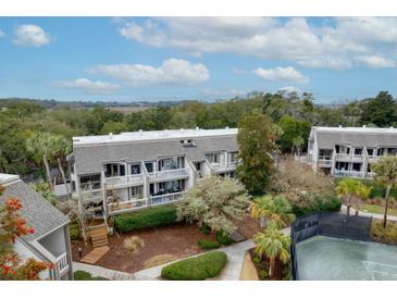 Beautiful townhouse with charming balconies and lush greenery surrounding the building at 1613 Live Oak Park, Seabrook Island, SC 29455