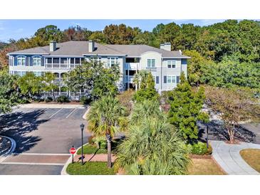 Beautiful building featuring screened-in porches and manicured landscaping at 1623 Telfair Way, Charleston, SC 29412