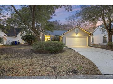 Charming one-story home with a two-car garage, landscaped yard, and inviting curb appeal at 1942 Oak Tree Ln, Mount Pleasant, SC 29464