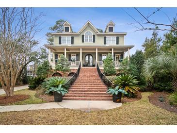 Charming two-story home with a welcoming front porch and manicured landscaping at 2217 Beckenham Dr, Mount Pleasant, SC 29466