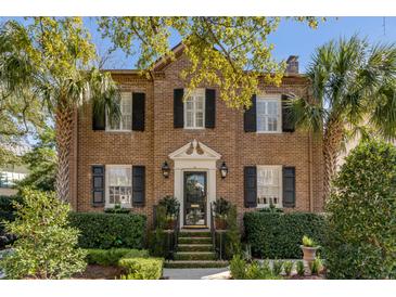 Charming two-story brick home with black shutters and well-manicured landscaping at 40 New St, Charleston, SC 29401