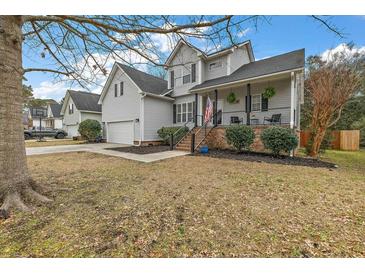 Charming two-story home with a welcoming front porch and well-maintained landscaping at 59 Oyster Point, Charleston, SC 29412