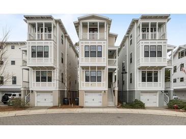 Three-story townhomes featuring private garages, multiple balconies and neutral color scheme at 972 Key Colony Ct, Mount Pleasant, SC 29464