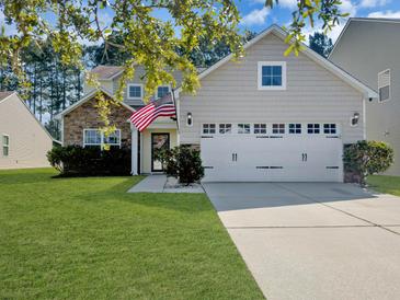 Charming two-story home with stone accents, attached two-car garage and well manicured lawn at 141 Beacon Falls Ct, Summerville, SC 29486