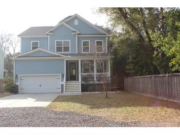 Charming two-story home with a welcoming front porch and a well-manicured lawn at 1601 Secessionville Rd, Charleston, SC 29412